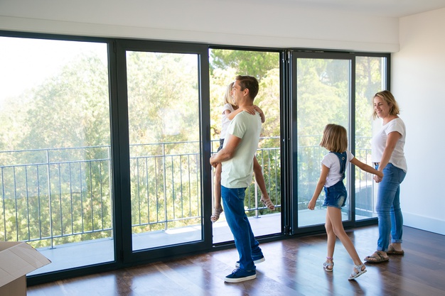 happy-father-with-daughter-standing-near-open-balcony-smiling_74855-9994